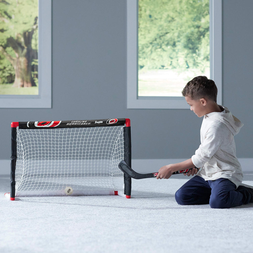 Franklin Sports Carolina Hurricanes Mini Hockey Set - Knee Hockey Goal, Ball, & 2 Hockey Stick Combo Set - Mini Goal Net - Nhl O
